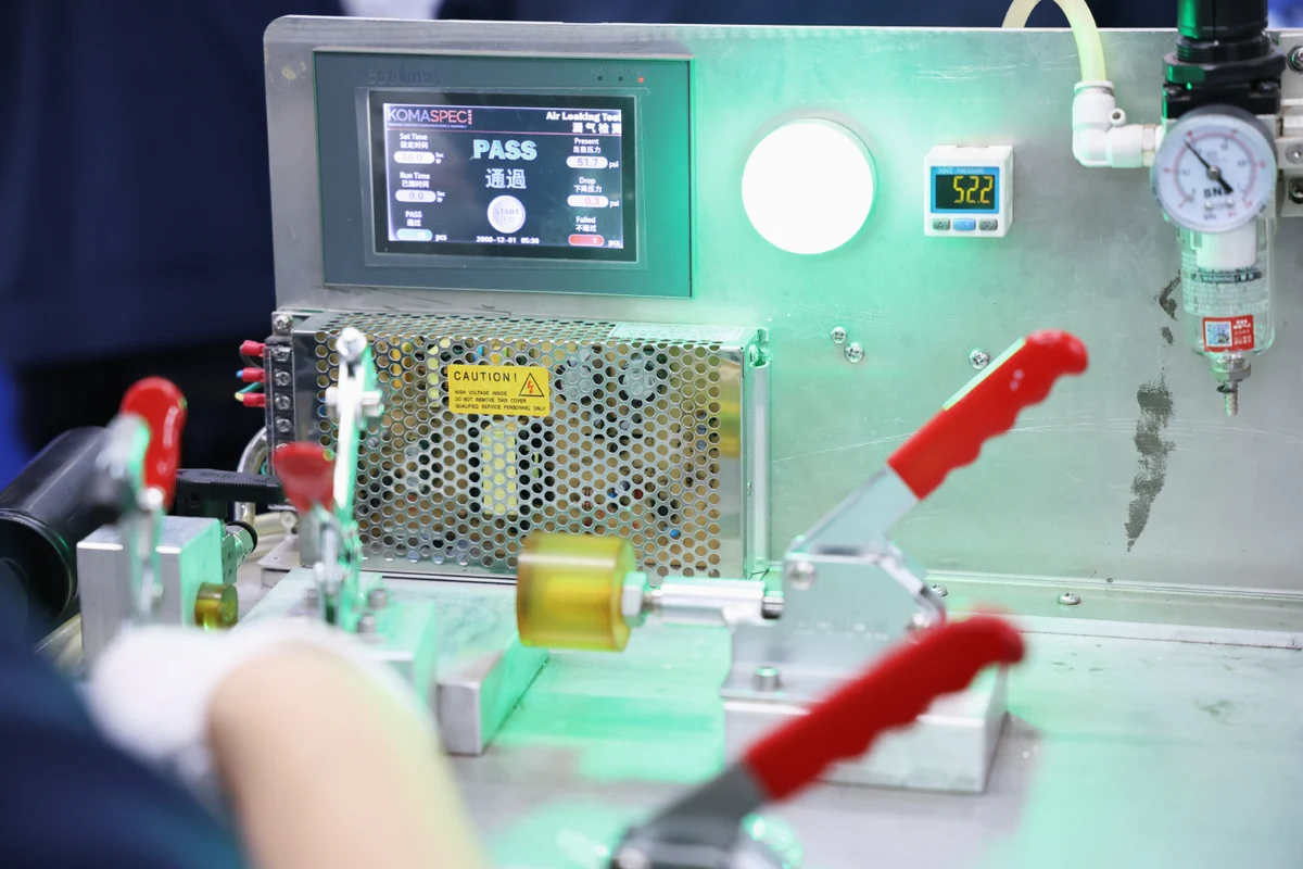 Komaspec air leak tester showing a PASS result with pressure and pressure-drop readings on screen