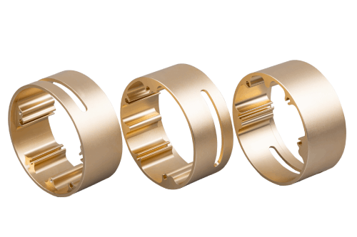 Two stainless steel CNC-turned bushing parts with precision slots