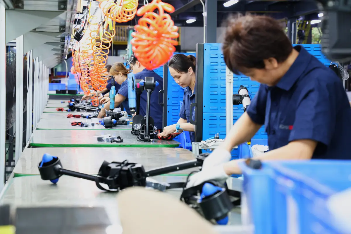Workers assembling products on a production line during the new product introduction process