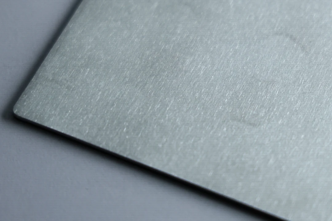 Brushed aluminum sample at 600 grit showing a near-uniform satin surface and faint lines