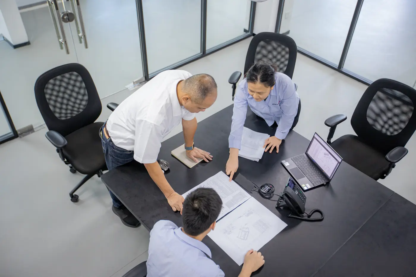 Komaspec engineers reviewing technical drawings