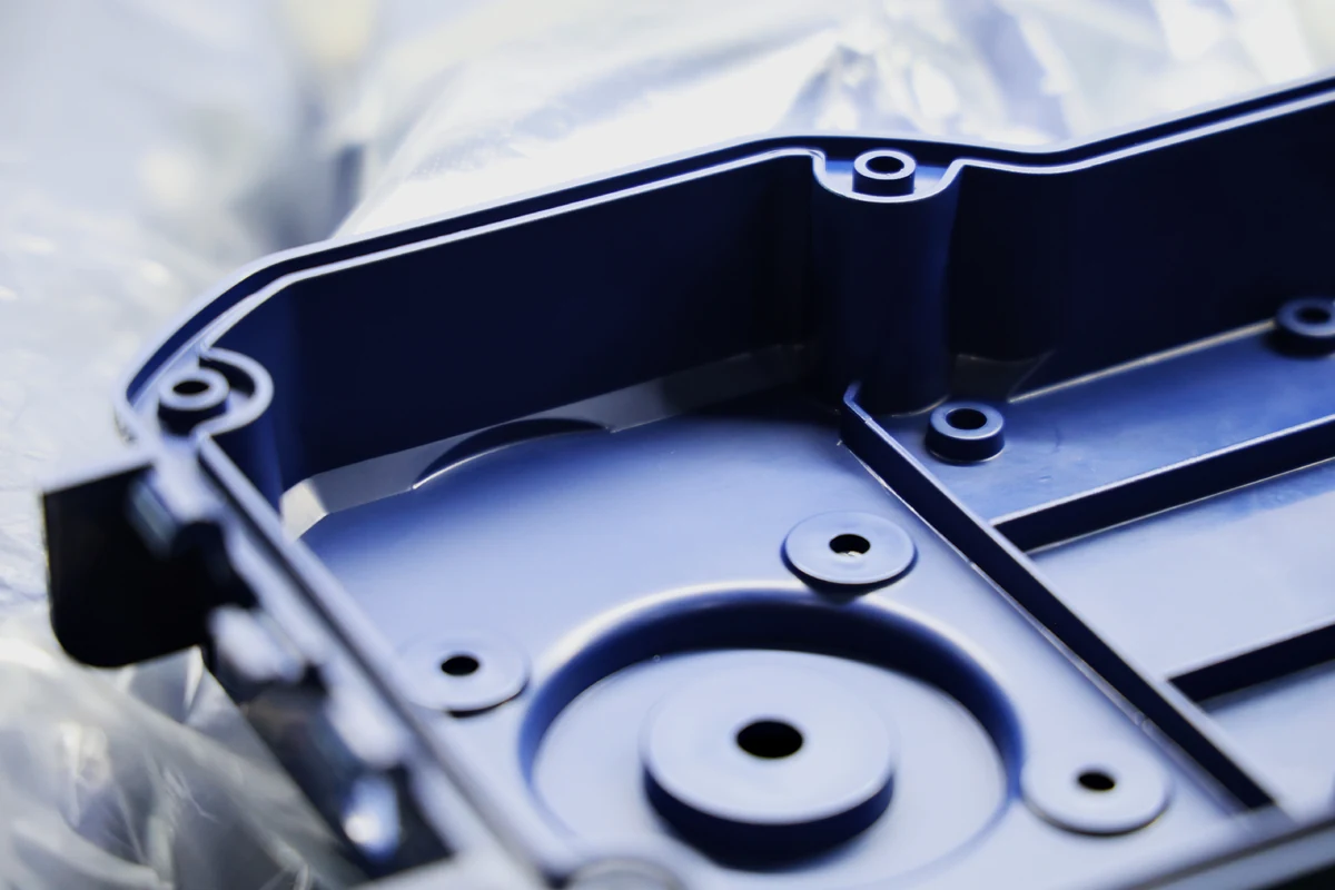 Close-up of a molded plastic housing showing cored bosses, ribs and radiused internal corners