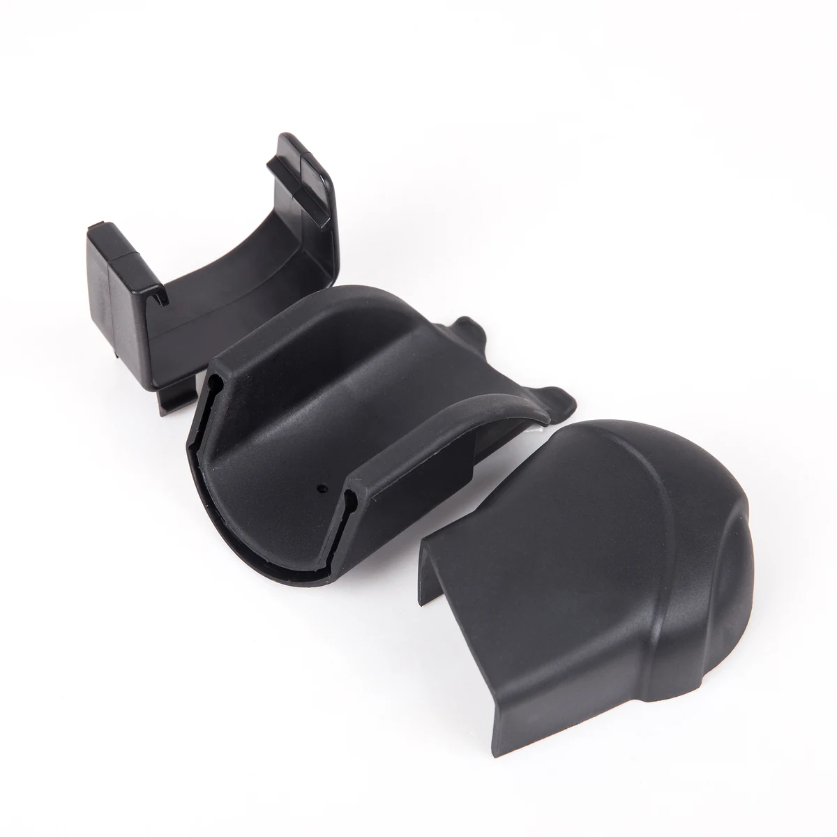Disassembled black molded plastic components with a matte textured finish