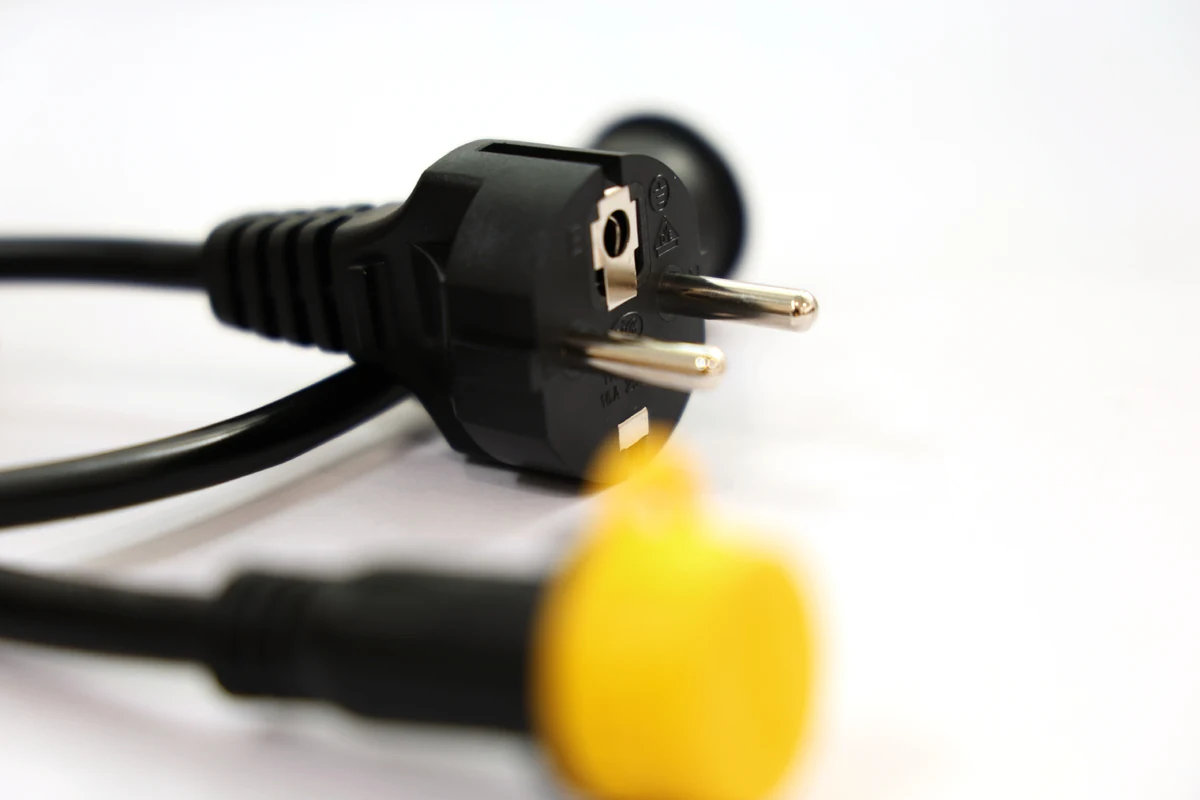 Close-up of an electrical plug and cable with molded overmolding around the cable connection