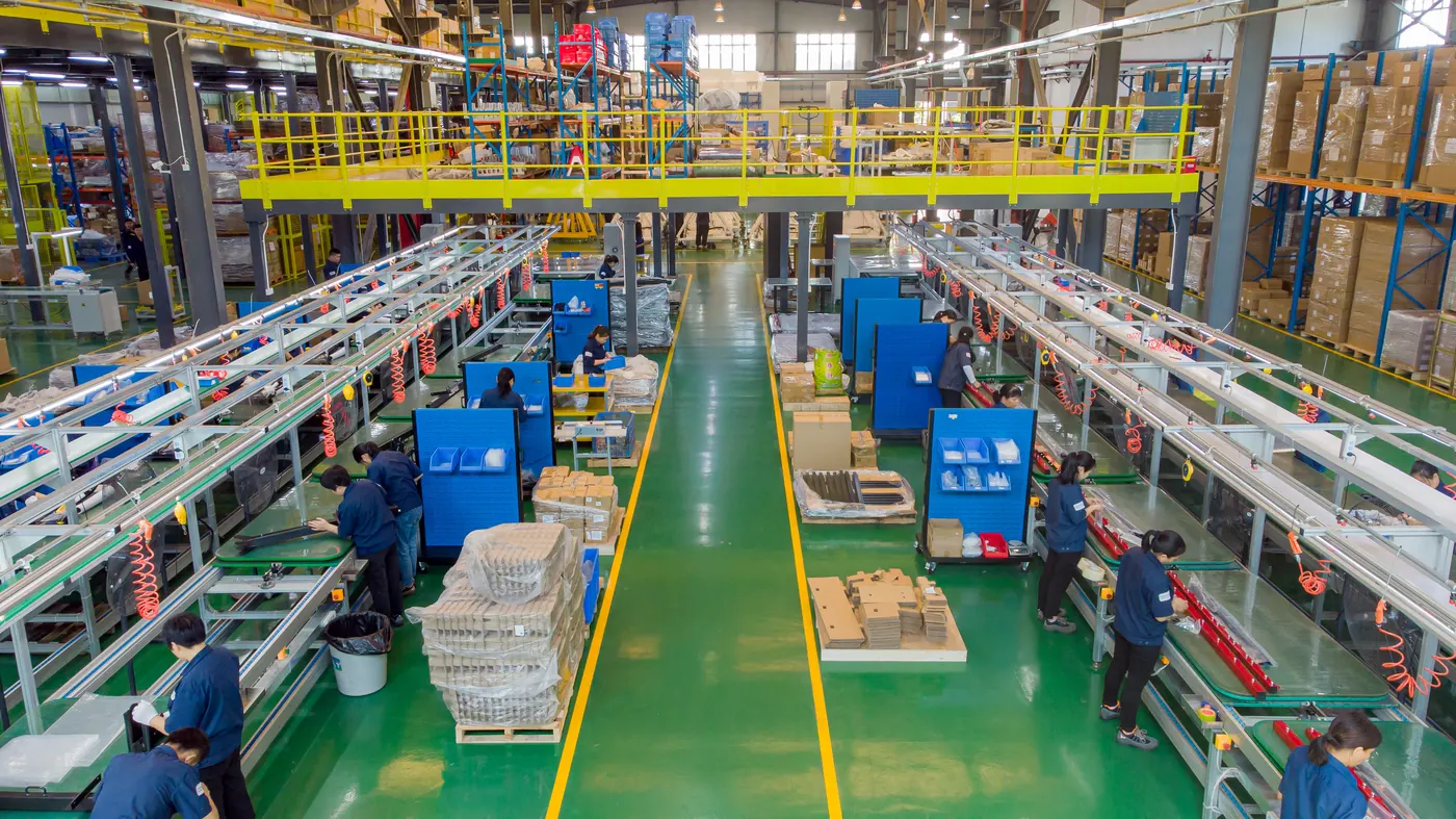 Contract manufacturing production floor with CNC sheet metal fabrication and assembly lines at Komaspec